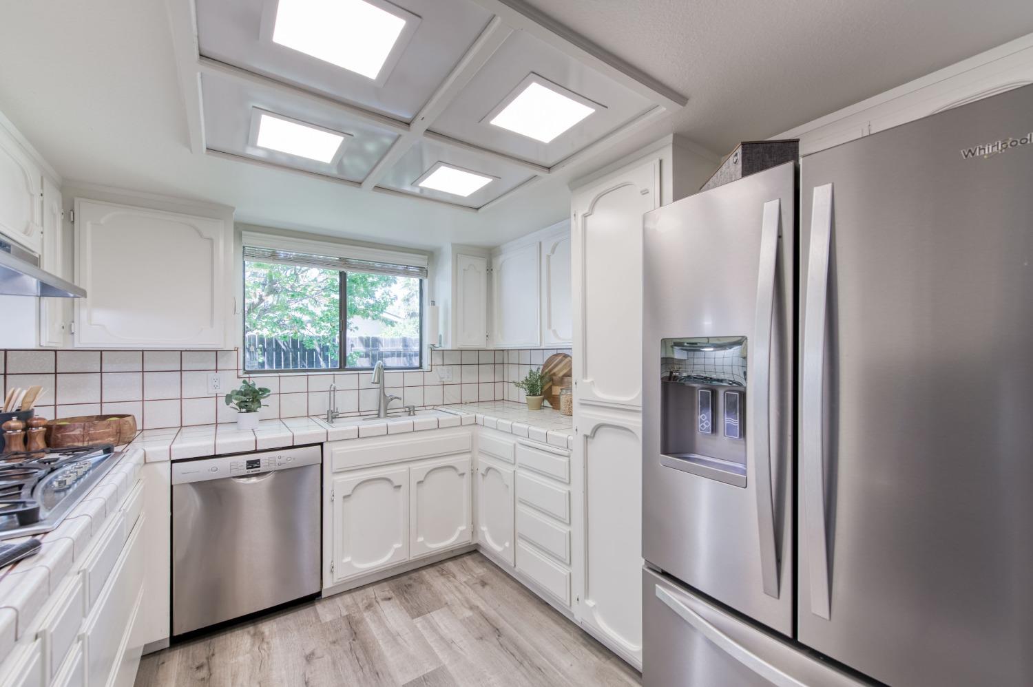 133 North Cindy Avenue Clovis, CA 93612 - Photo 6 of 19 a kitchen with white cabinets and white appliances