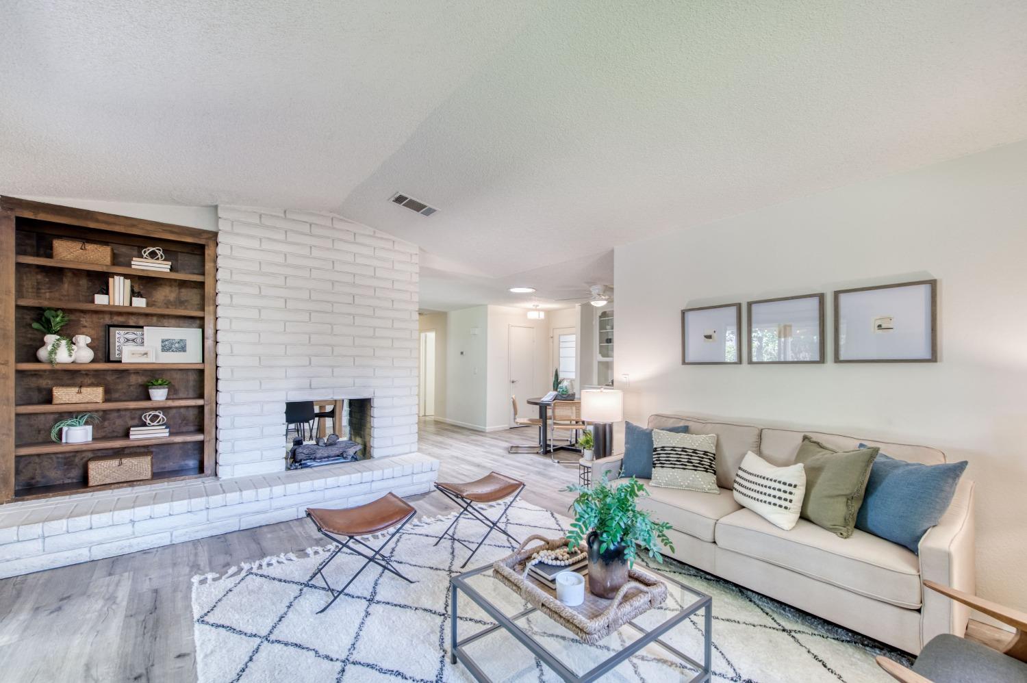 133 North Cindy Avenue Clovis, CA 93612 - Photo 7 of 19 a living room with furniture and a fireplace