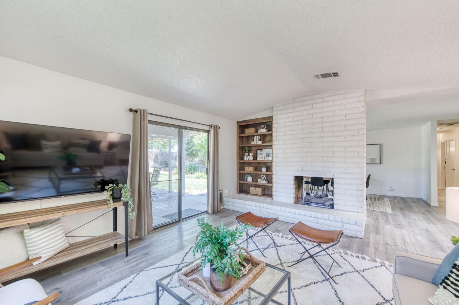 133 North Cindy Avenue Clovis, CA 93612 - Photo 8 of 19 a living room with furniture and a fireplace