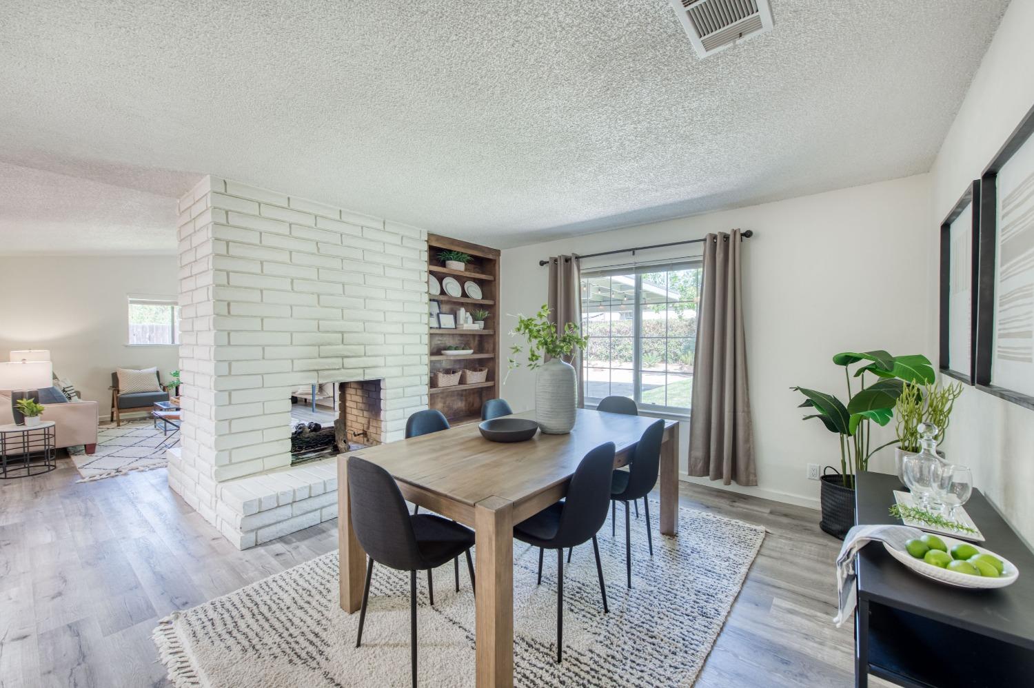 133 North Cindy Avenue Clovis, CA 93612 - Photo 10 of 19 a view of a dining room with furniture window and wooden floor