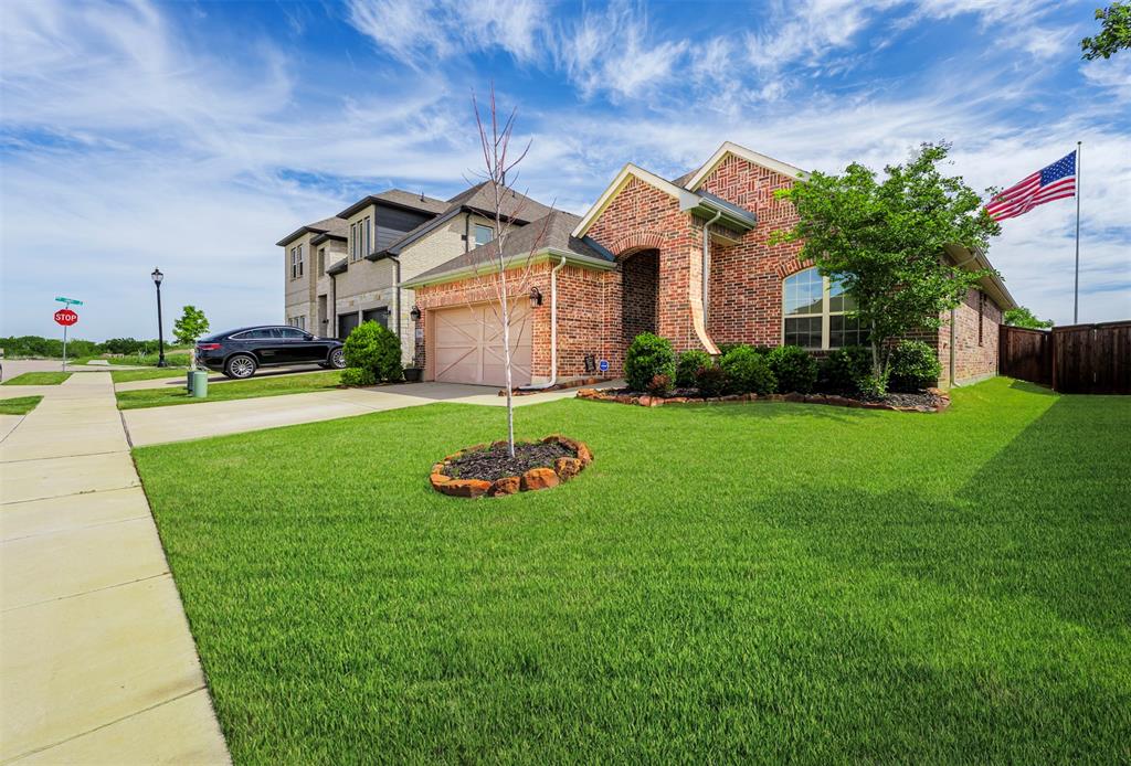 709 Bent Brook Road Oak Point, TX 75068 - Photo 23 of 24 View of front of home with concrete driveway, an attached garage, brick siding, and a front yard