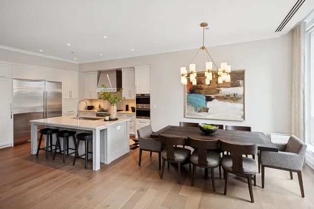 a kitchen with a dining table chairs and granite counter tops