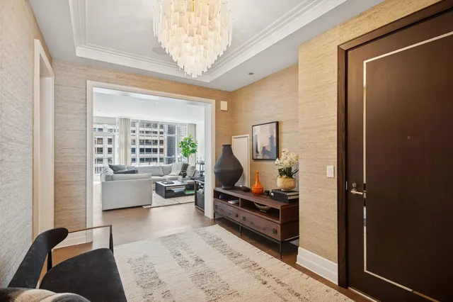 a living room with furniture and a chandelier