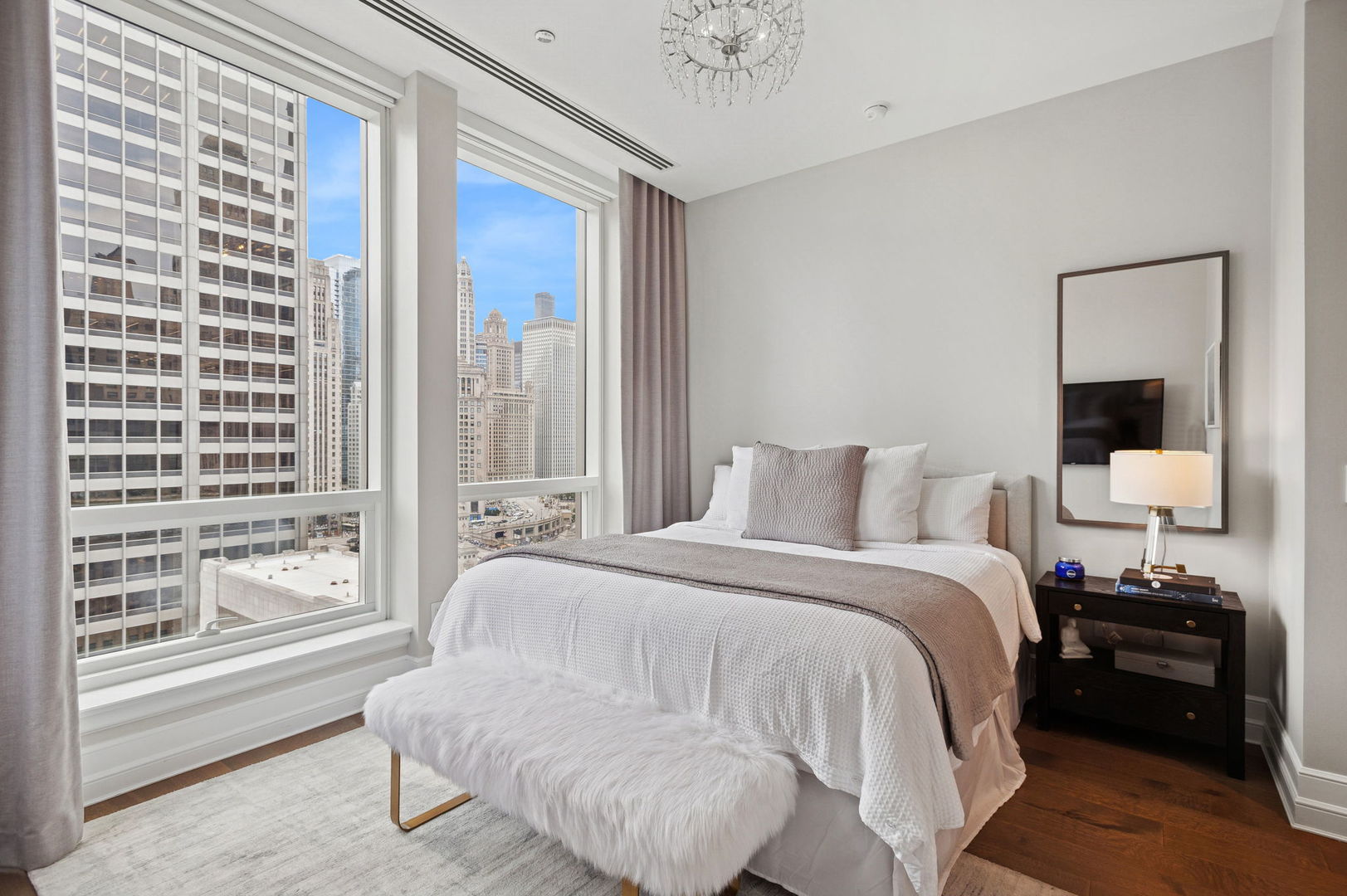 435 North Michigan Avenue, Unit 1112 Chicago, IL 60611 - Photo 42 of 70 a large bedroom with a bed and wooden floor