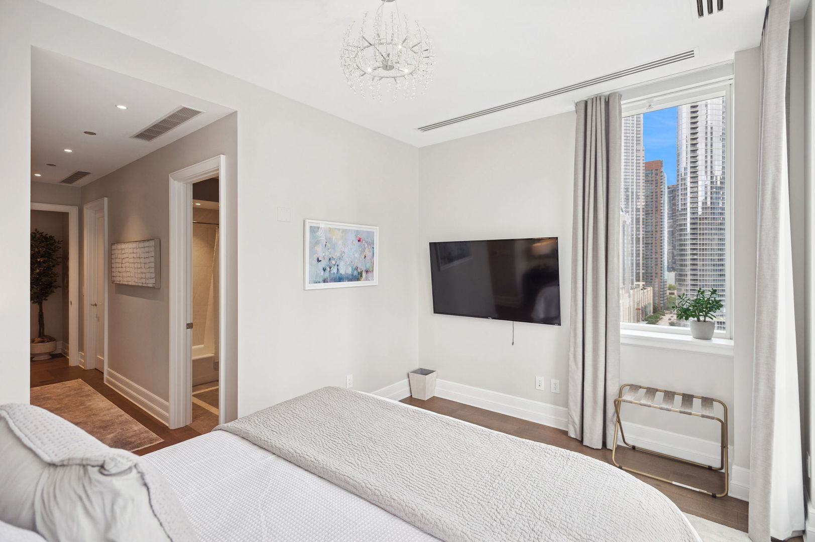 435 North Michigan Avenue, Unit 1112 Chicago, IL 60611 - Photo 43 of 70 a bedroom with a bed and a flat screen tv