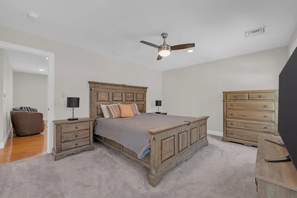 a bedroom with a bed and a ceiling fan