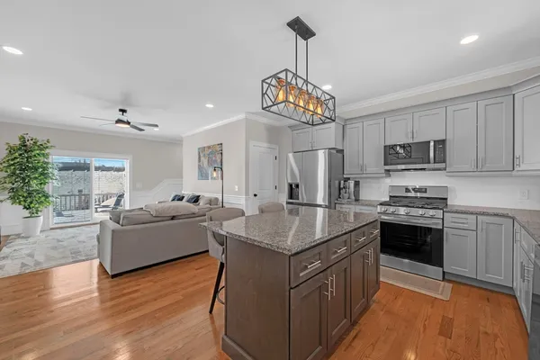 a kitchen with kitchen island granite countertop stainless steel appliances lots of counter top space