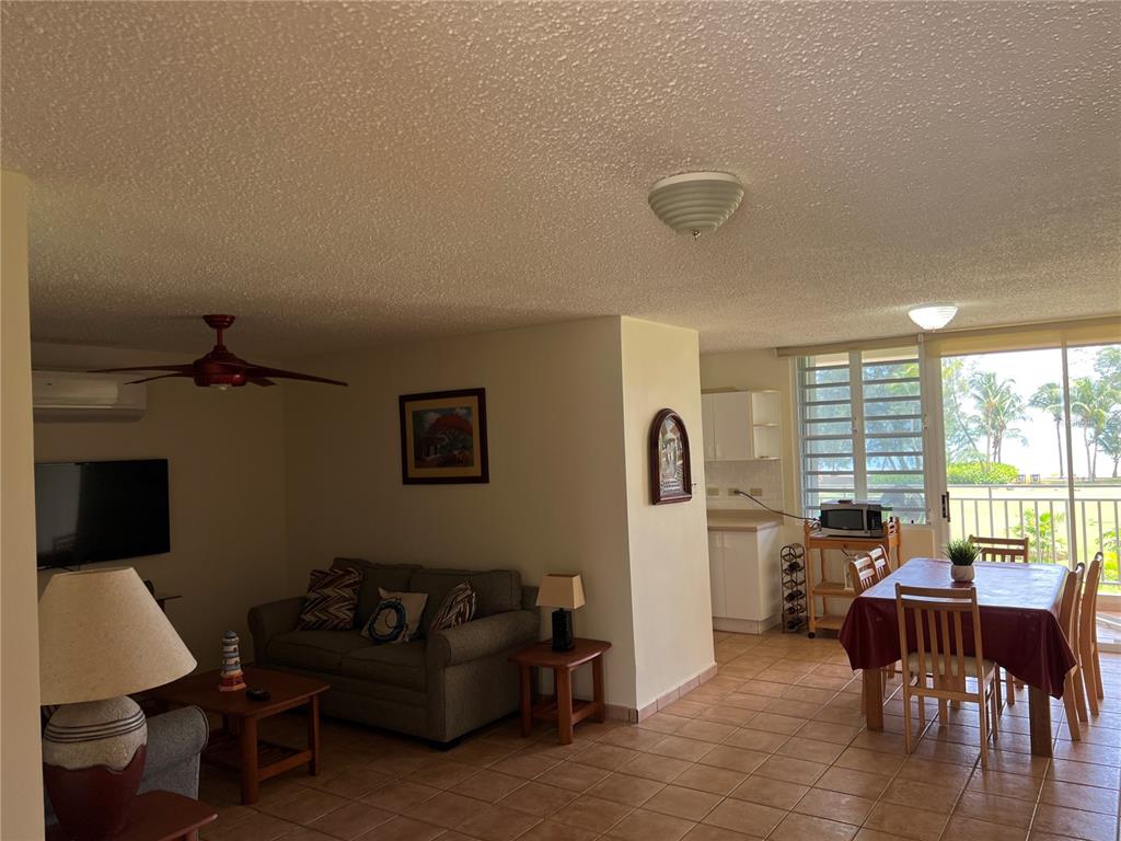 968 Camino Las Picüas, Unit 30 Rio Grande, Río Grande 00745 - Photo 8 of 24 a living room with furniture and a large window