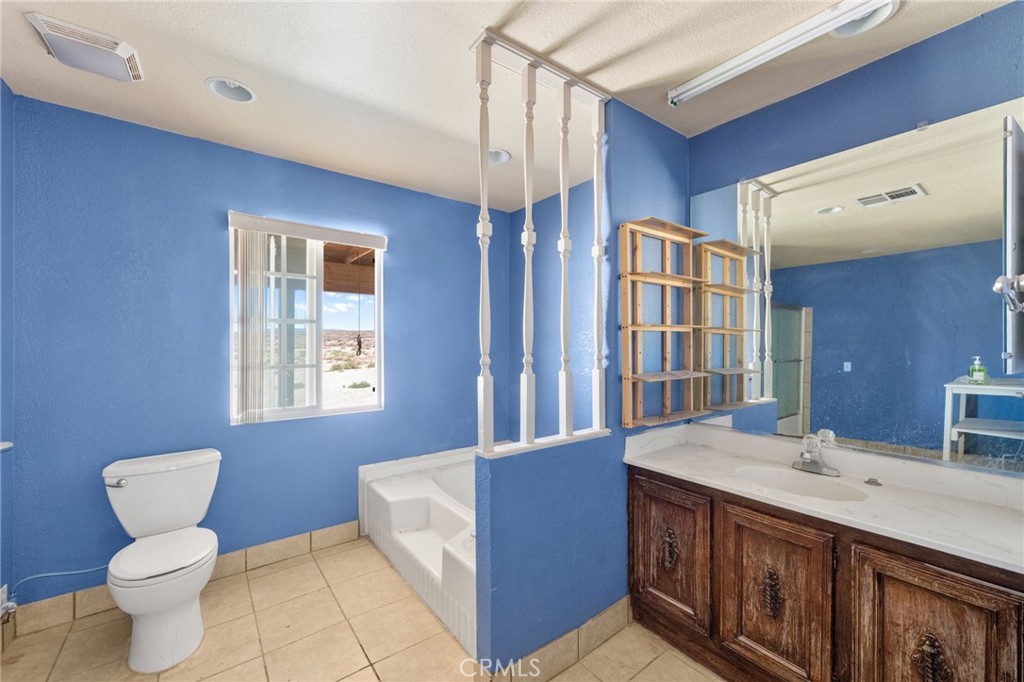 36990 Cambria Road Lucerne Valley, CA 92356 - Photo 11 of 13 a bathroom with a sink a toilet and shower