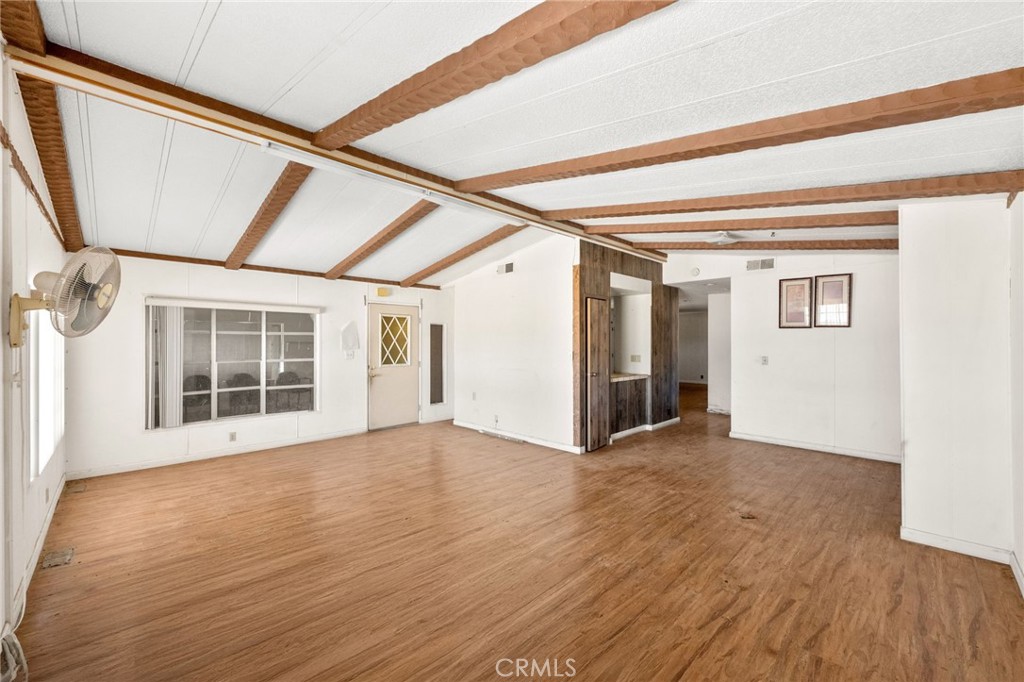 36990 Cambria Road Lucerne Valley, CA 92356 - Photo 8 of 13 a view of an empty room with wooden floor and a window