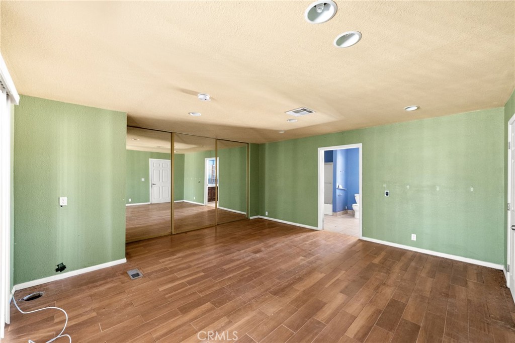 36990 Cambria Road Lucerne Valley, CA 92356 - Photo 10 of 13 a view of an empty room with window and wooden floor