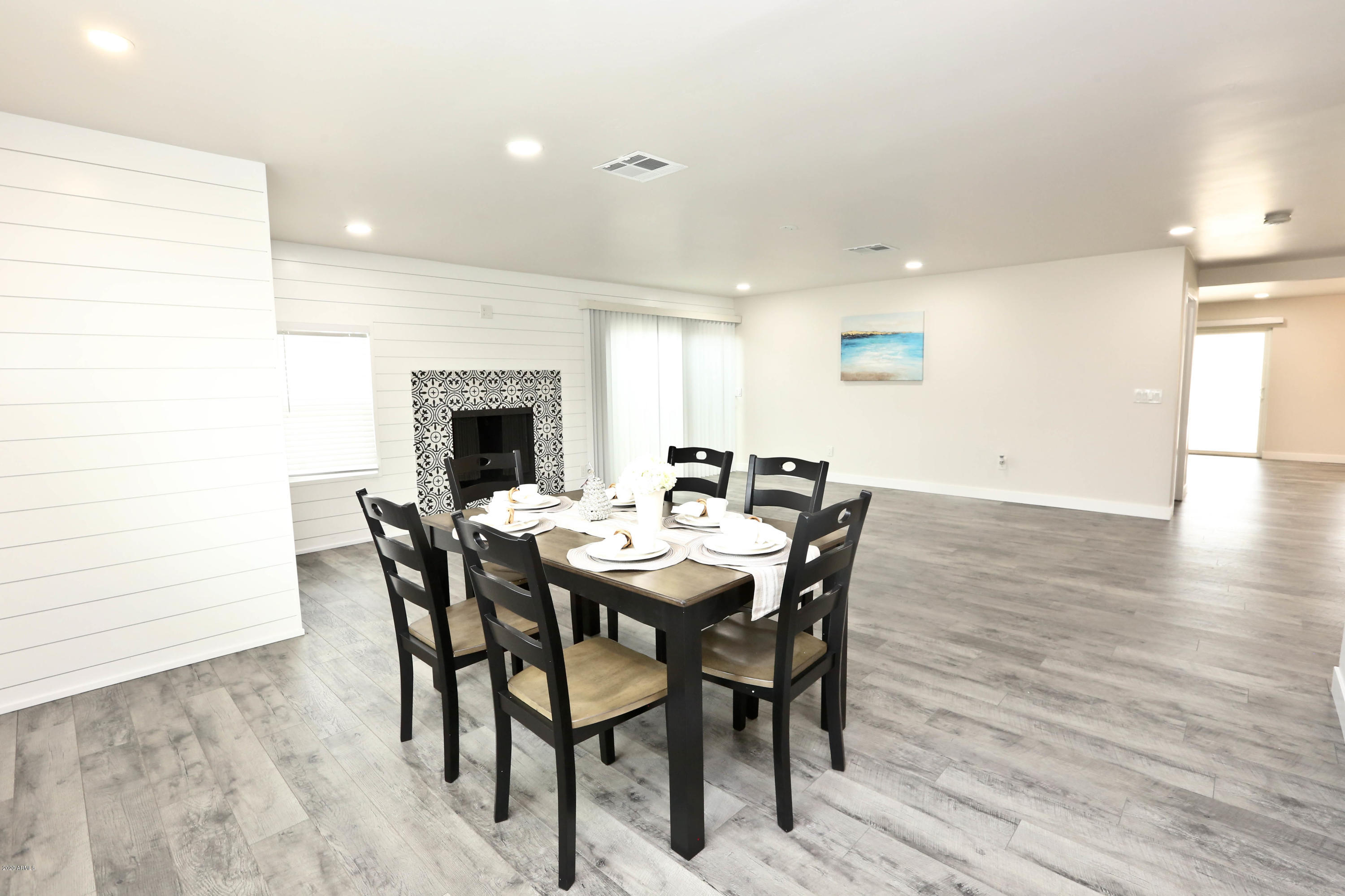 3414 East Camelback Road Phoenix, AZ 85018 - Photo 29 of 81 a view of a dining room with furniture and wooden floor
