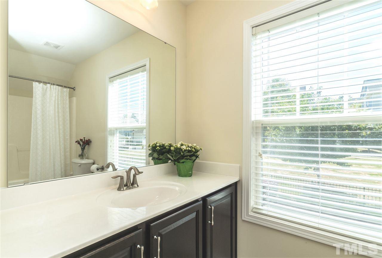1407 Rodessa Run Raleigh, NC 27607 - Photo 23 of 30 a bathroom with a sink and a mirror