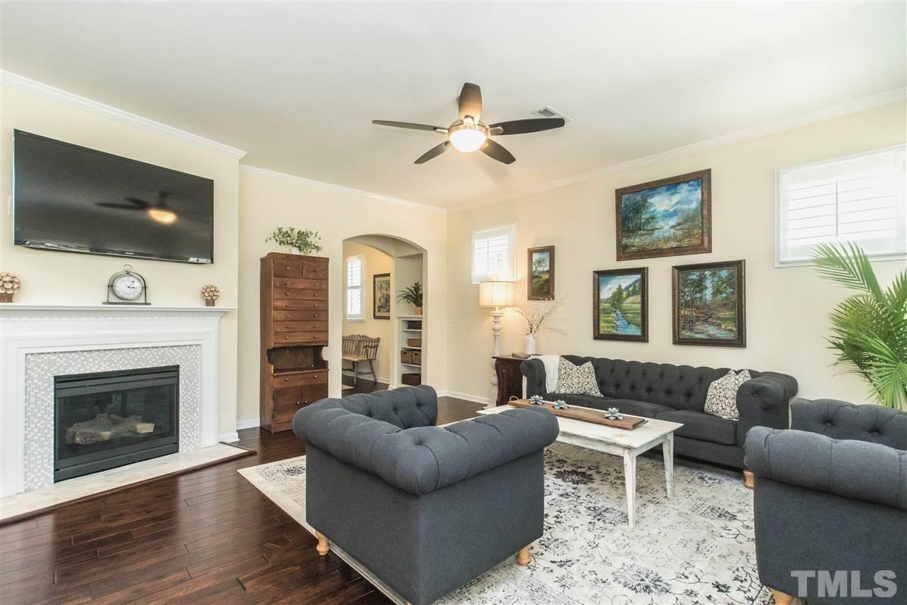1407 Rodessa Run Raleigh, NC 27607 - Photo 4 of 30 a living room with furniture a flat screen tv and a fireplace