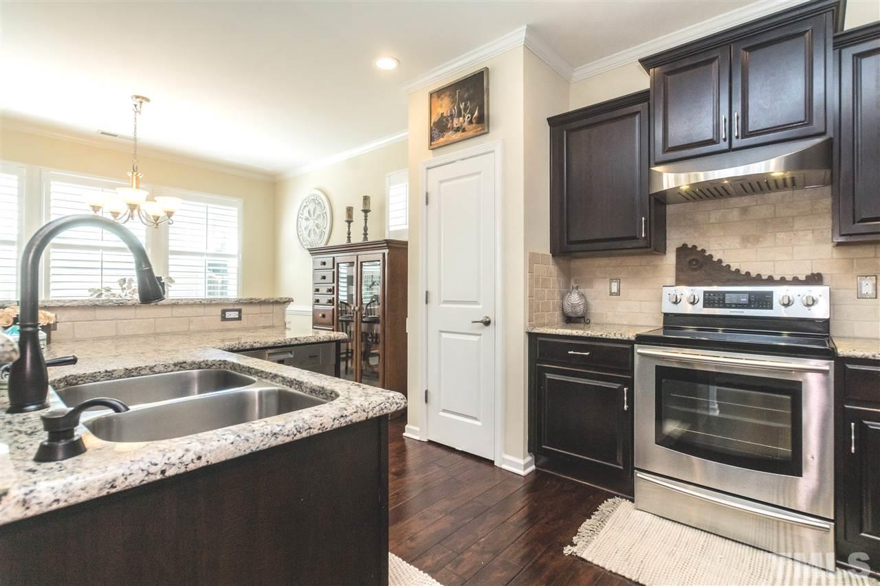 1407 Rodessa Run Raleigh, NC 27607 - Photo 5 of 30 a kitchen with a sink stove and refrigerator