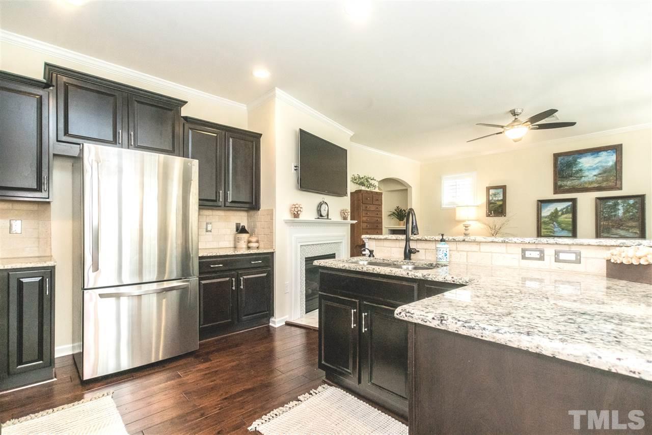 1407 Rodessa Run Raleigh, NC 27607 - Photo 6 of 30 a kitchen with stainless steel appliances granite countertop a refrigerator a stove and a sink