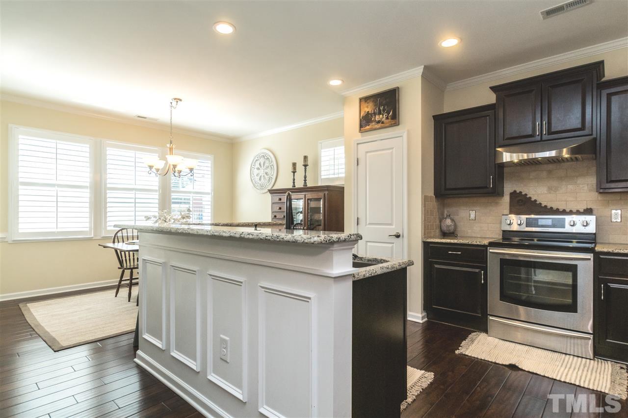 1407 Rodessa Run Raleigh, NC 27607 - Photo 8 of 30 a kitchen with stainless steel appliances granite countertop a stove and a sink