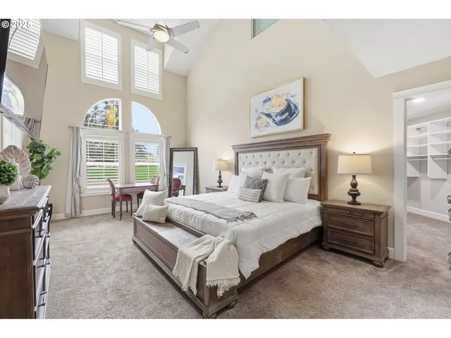 a bed room with a bed and a large window