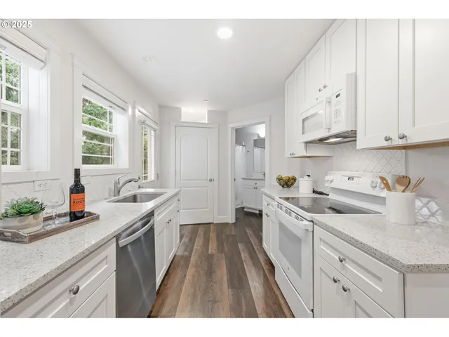 a kitchen with a sink stove and cabinets