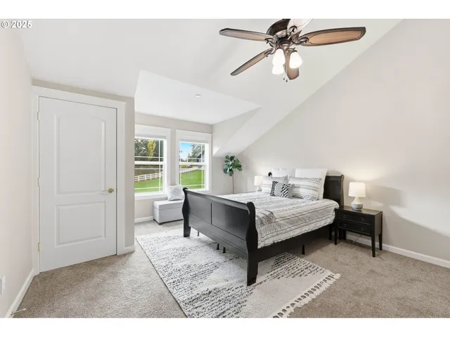 a living room with furniture a flat screen tv and a table