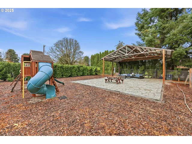 a backyard of a house with table and chairs