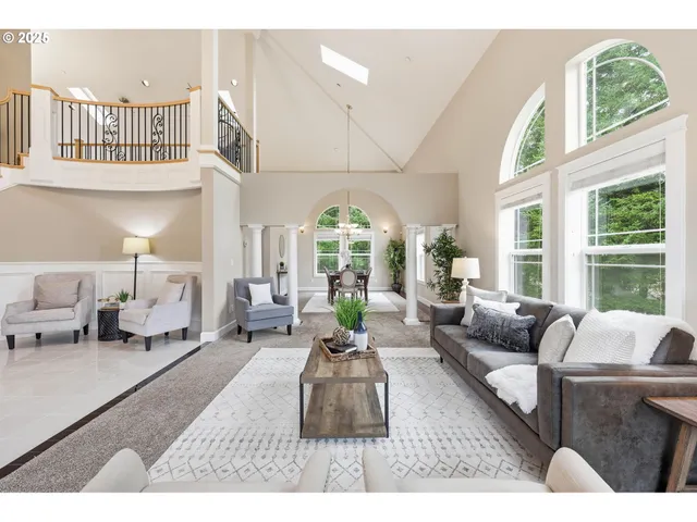 a living room with furniture fireplace and a large window