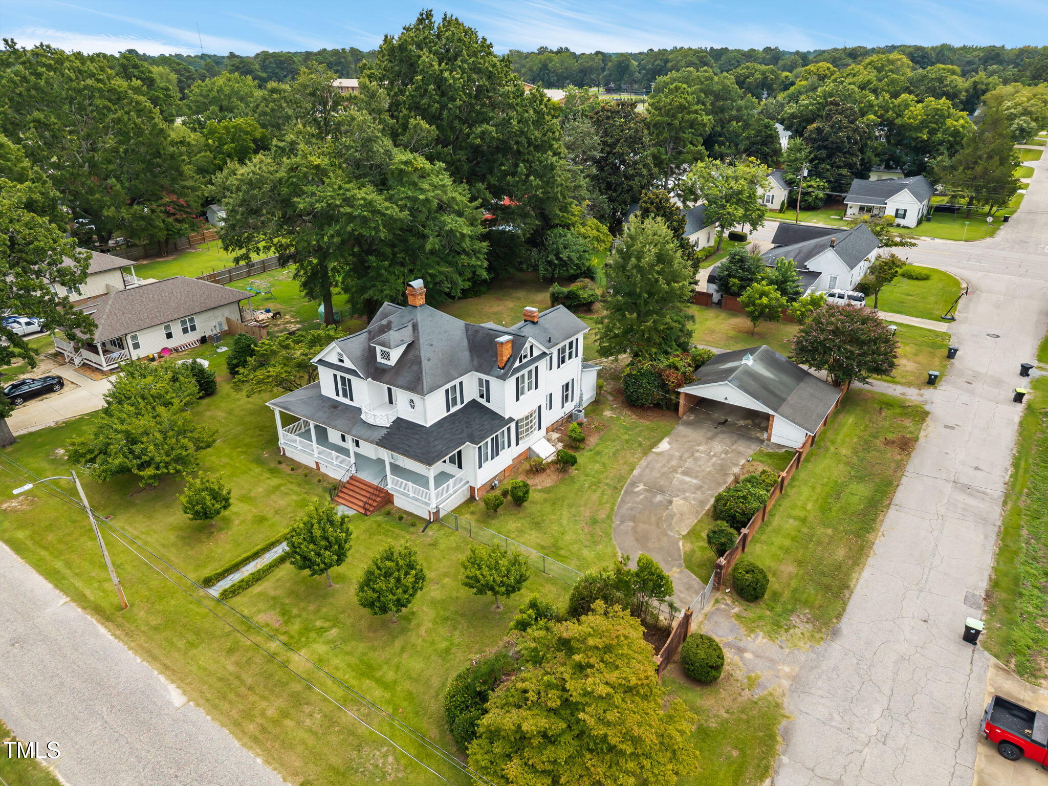 an aerial view of a house with a garden and swimming pool
