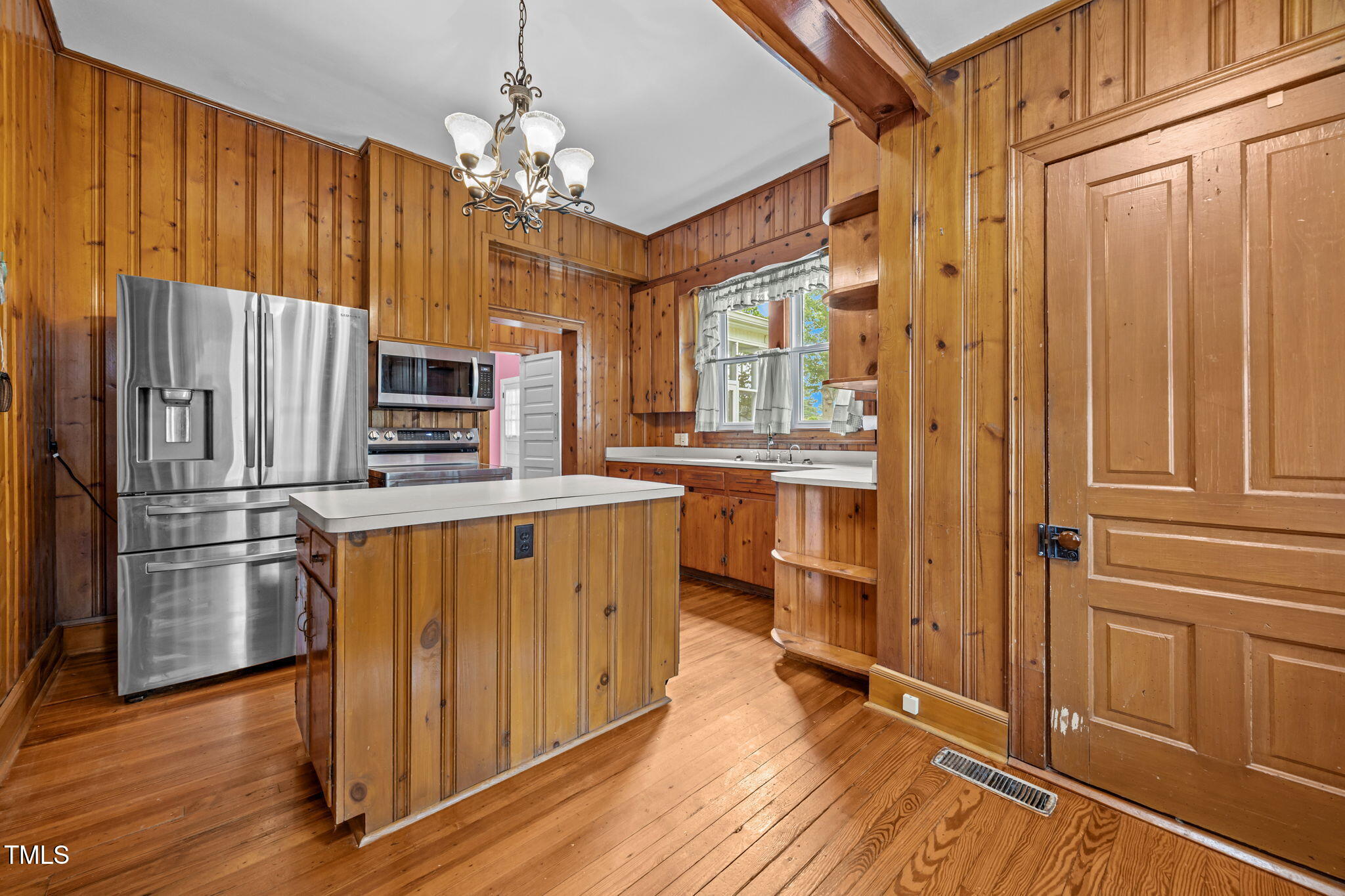301 East H Street Erwin, NC 28339 - Photo 11 of 56 a kitchen with stainless steel appliances a refrigerator and a stove top oven