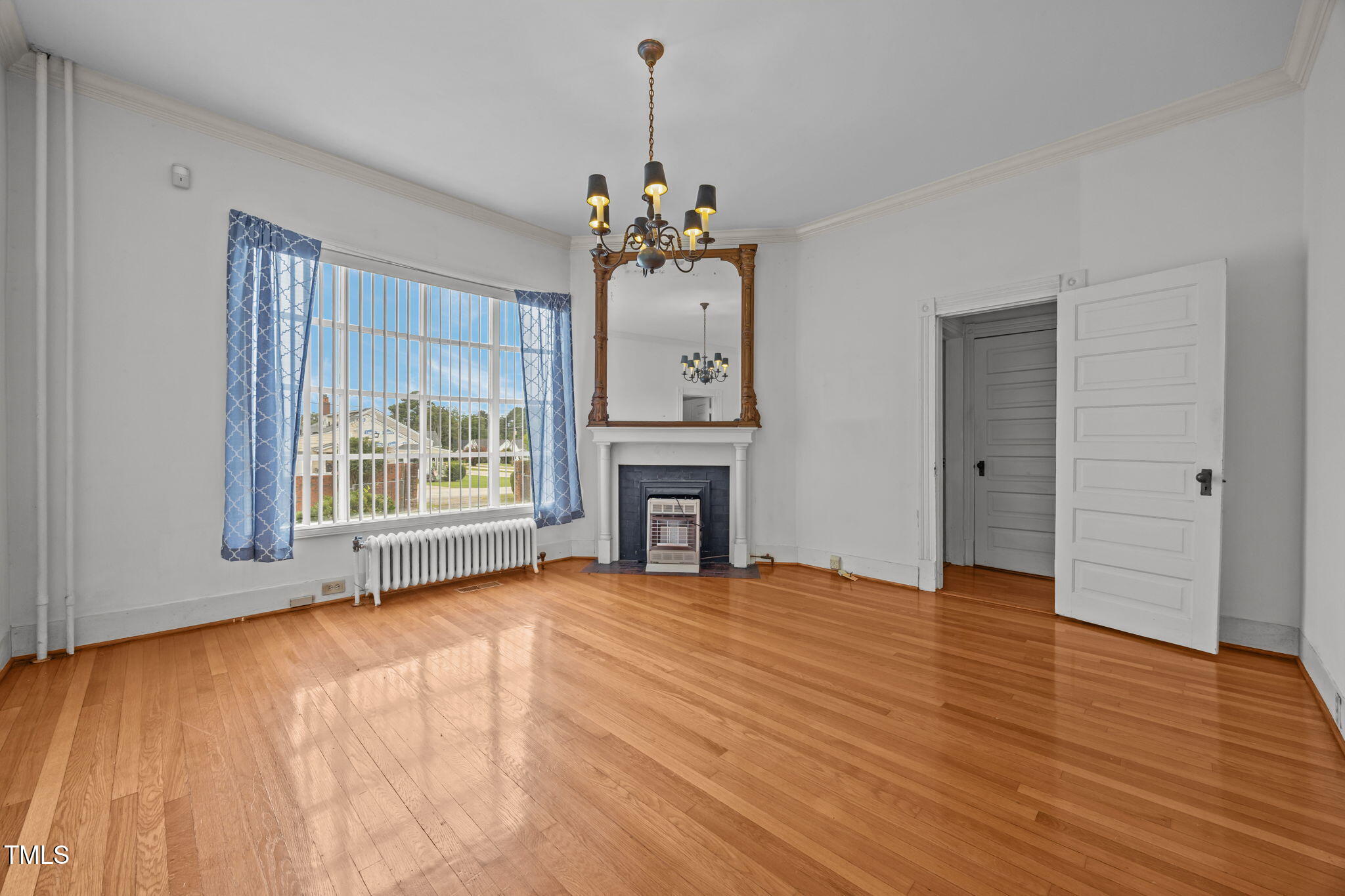 301 East H Street Erwin, NC 28339 - Photo 18 of 56 a view of an empty room with window and wooden floor