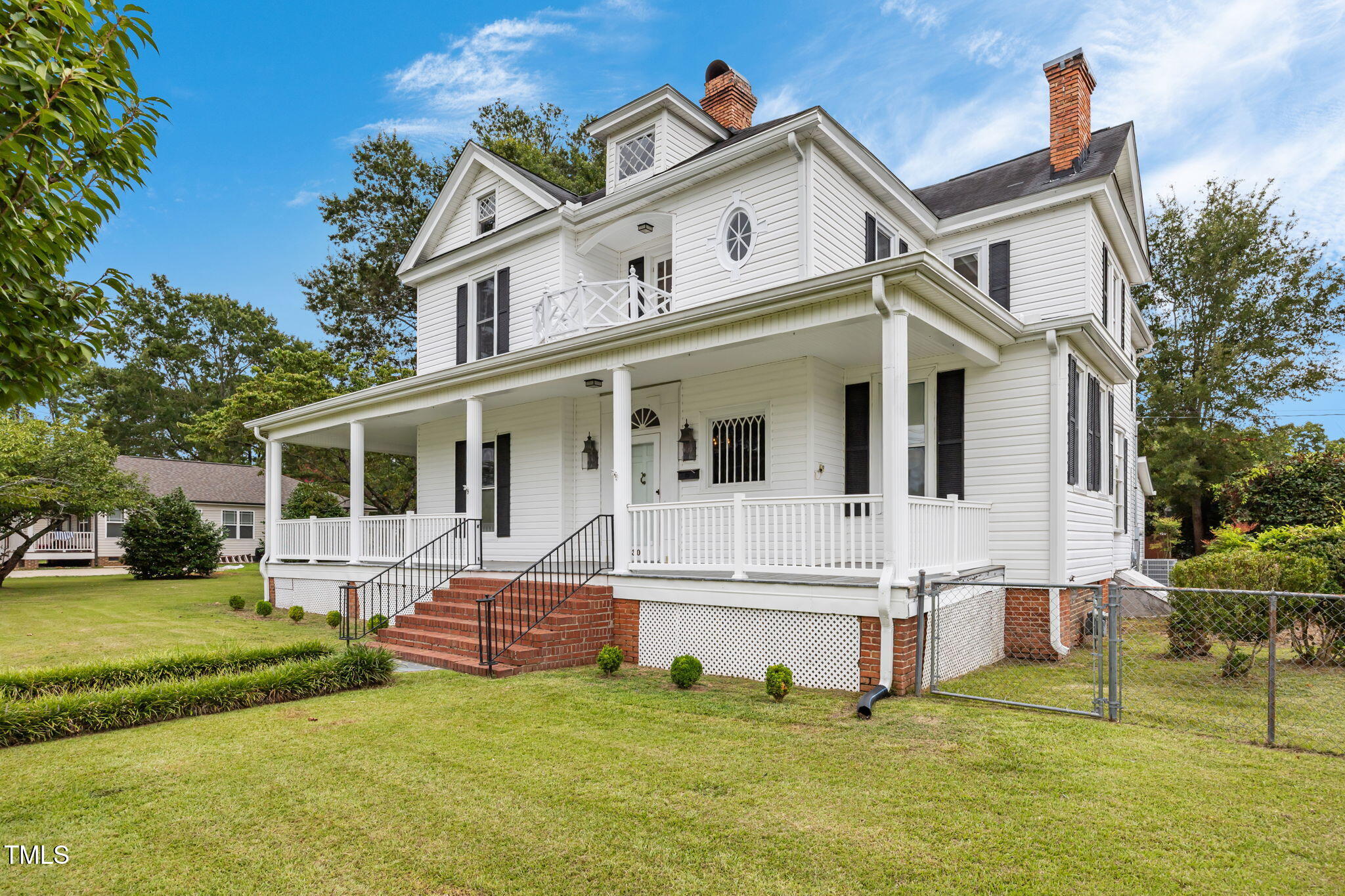 301 East H Street Erwin, NC 28339 - Photo 2 of 58 a view of a house with a big yard and large trees