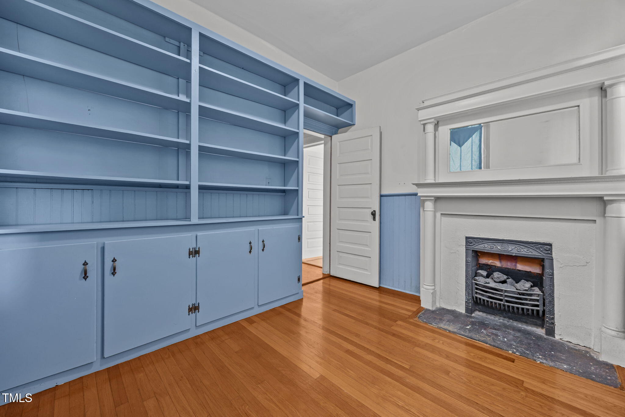 301 East H Street Erwin, NC 28339 - Photo 23 of 56 a view of an empty room with a fireplace and a window