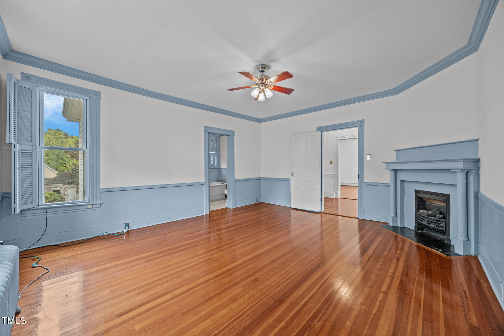 301 East H Street Erwin, NC 28339 - Photo 36 of 58 a view of an empty room with window and wooden floor