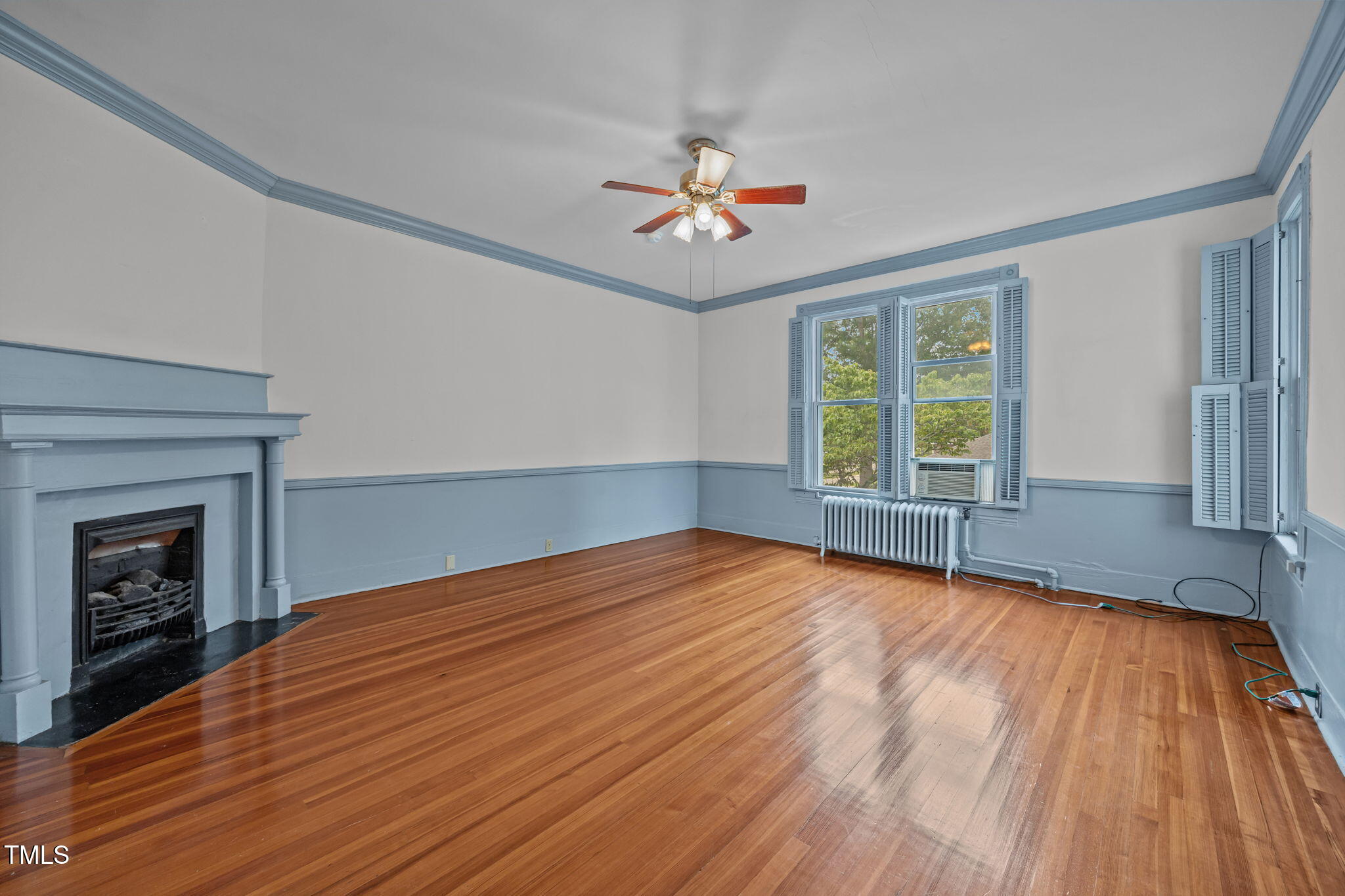 301 East H Street Erwin, NC 28339 - Photo 37 of 58 a view of an empty room with wooden floor fireplace and a window