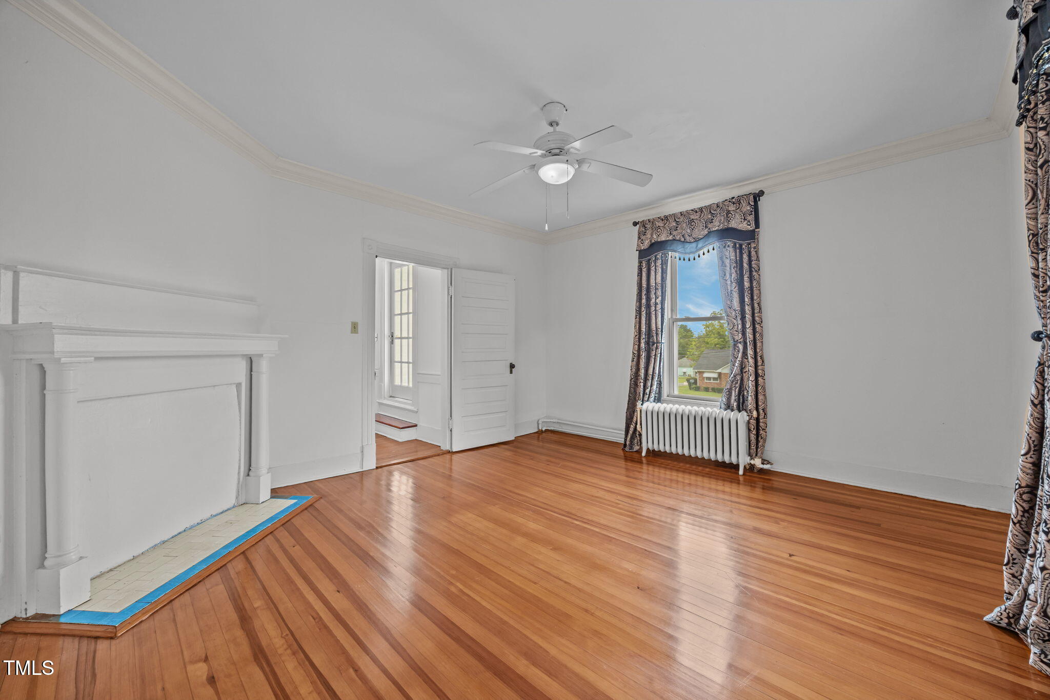 301 East H Street Erwin, NC 28339 - Photo 38 of 56 a view of an empty room with wooden floor and a window