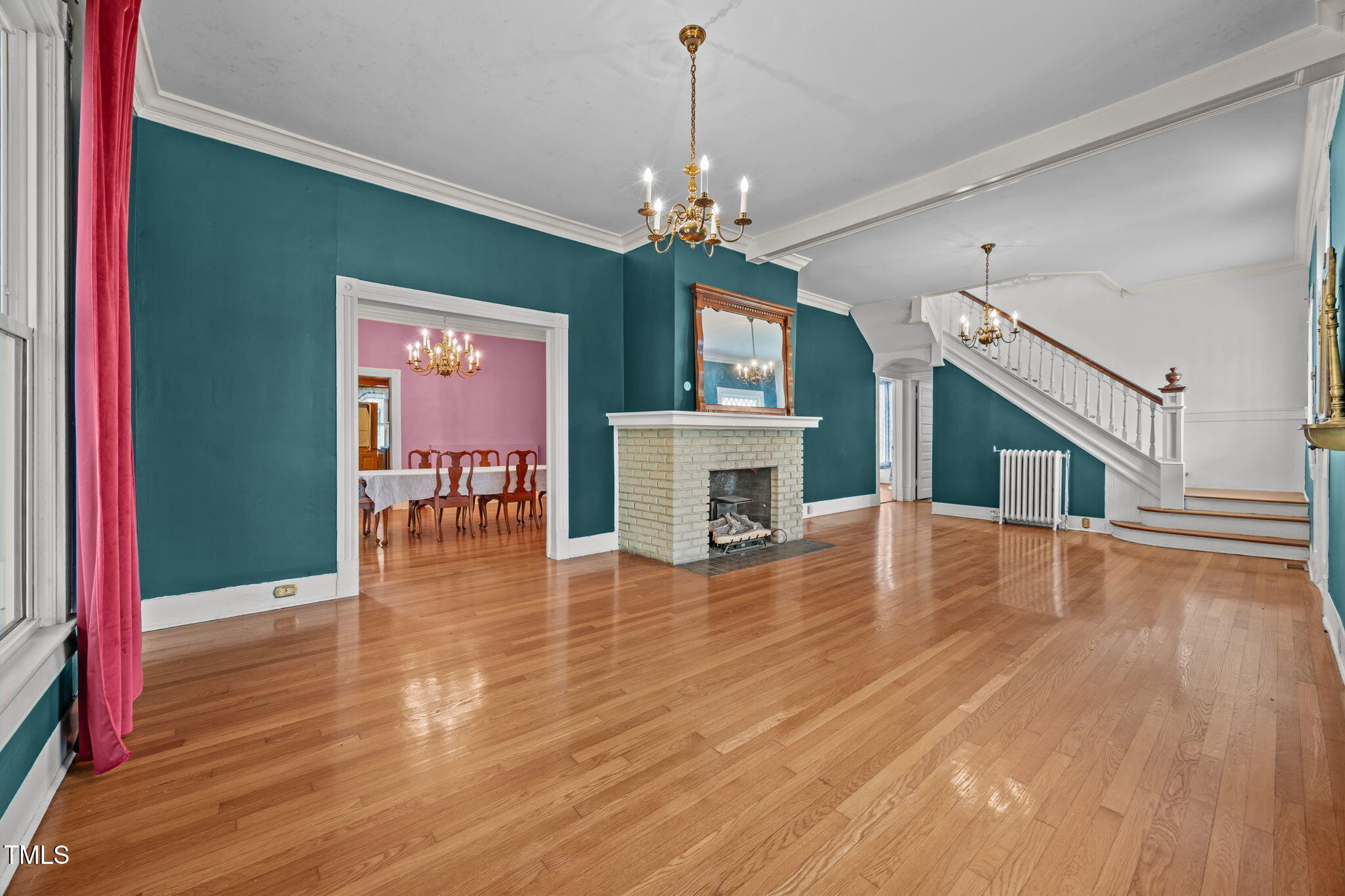 301 East H Street Erwin, NC 28339 - Photo 4 of 58 a view of a livingroom with a fireplace wooden floor and a chandelier
