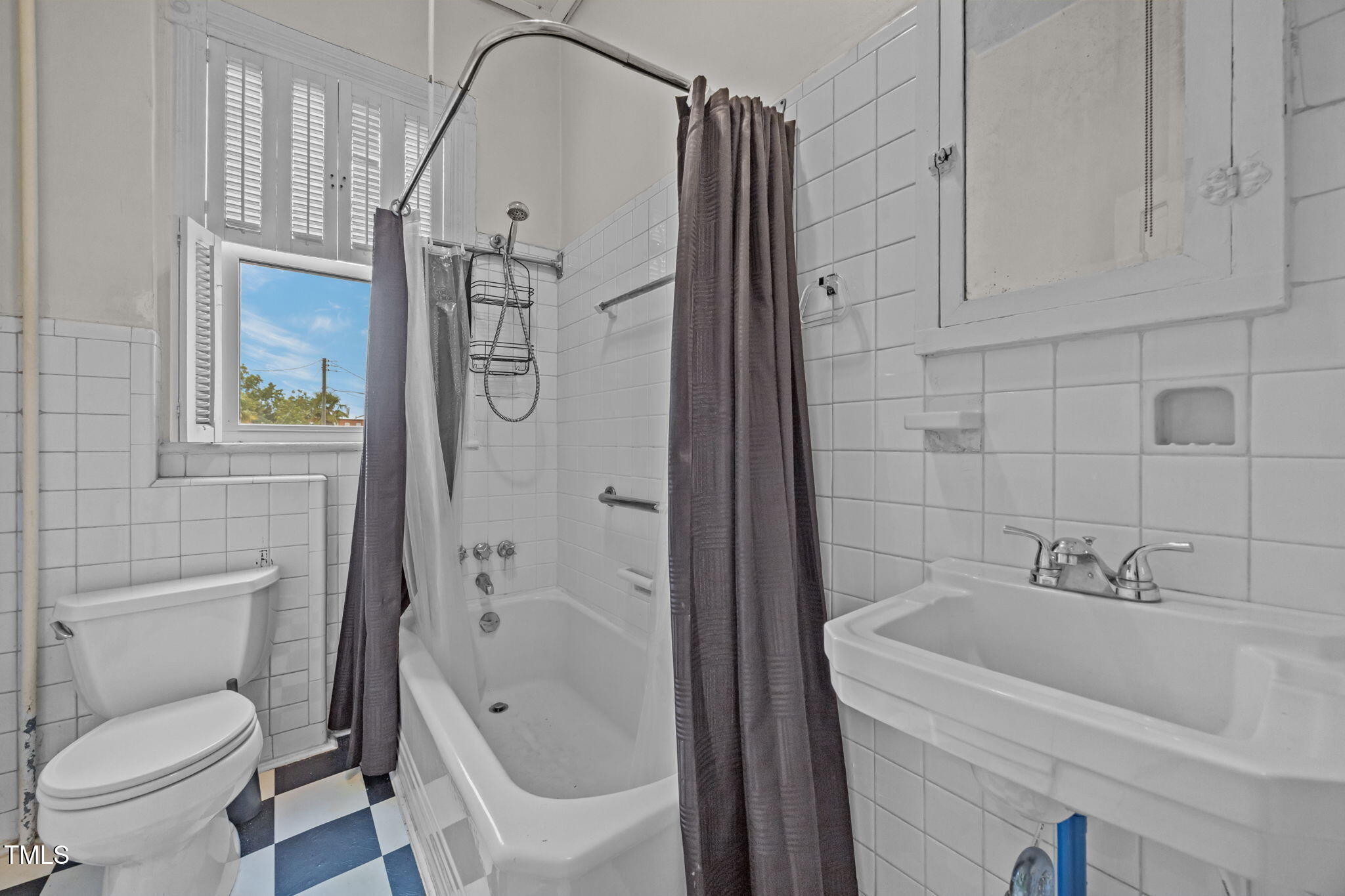 301 East H Street Erwin, NC 28339 - Photo 41 of 58 a bathroom with a sink a toilet and shower