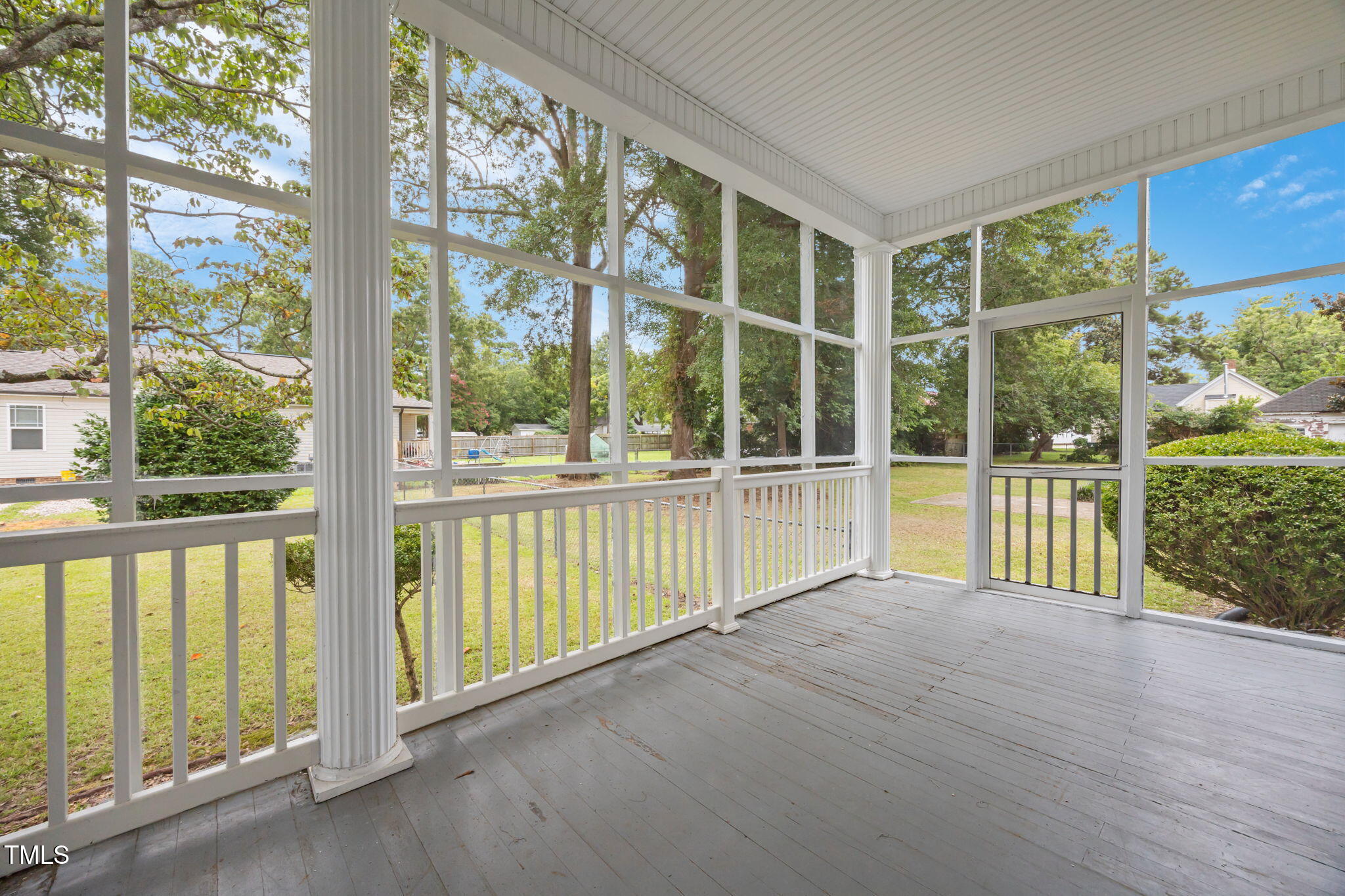 301 East H Street Erwin, NC 28339 - Photo 49 of 58 a view of an empty room with wooden floor and floor to ceiling windows