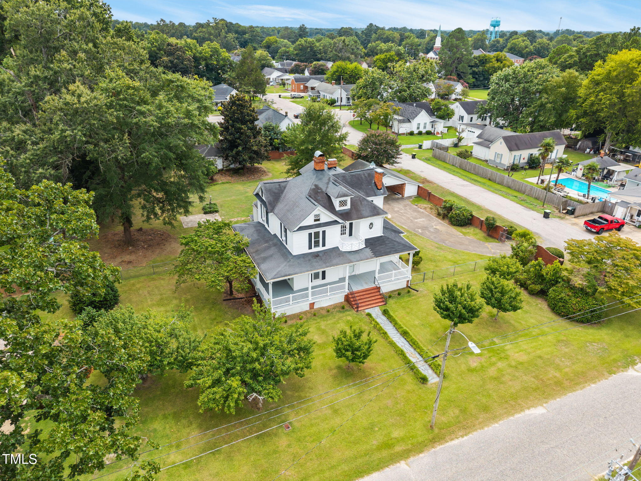 301 East H Street Erwin, NC 28339 - Photo 54 of 56 an aerial view of a house with a garden and swimming pool