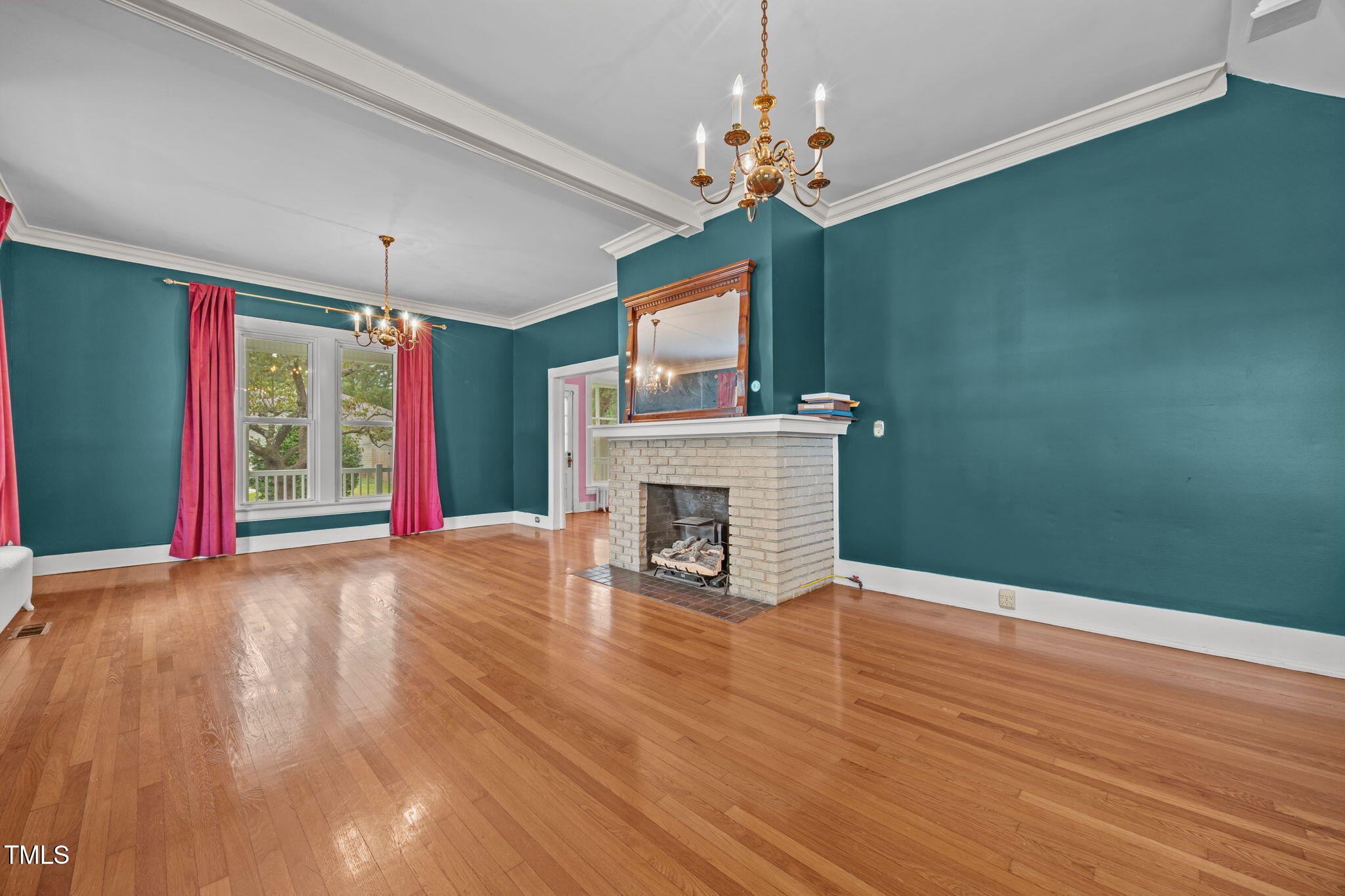 301 East H Street Erwin, NC 28339 - Photo 6 of 58 a view of a livingroom with a fireplace wooden floor and chandelier