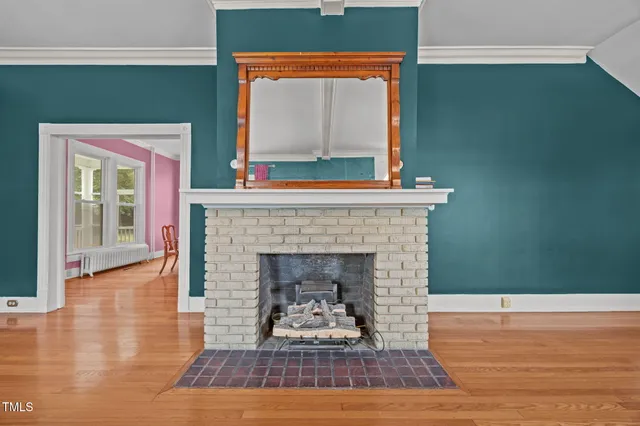 a living room with a fireplace and a floor to ceiling window