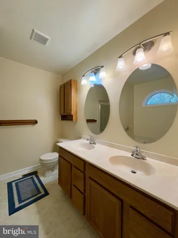 a bathroom with a double vanity sink and a mirror