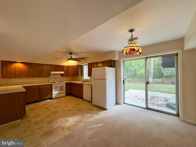 a view of a kitchen with a sink and a refrigerator