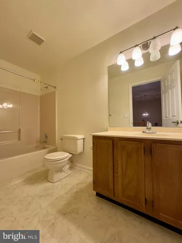 a bathroom with a sink mirror and toilet