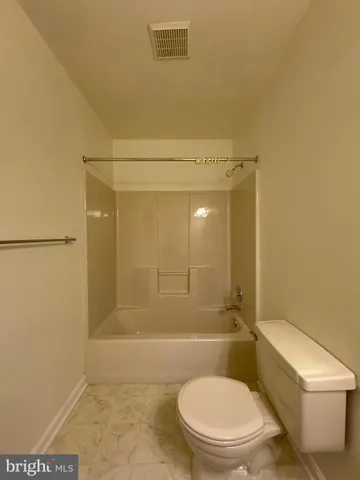 a bathroom with a shower and a toilet
