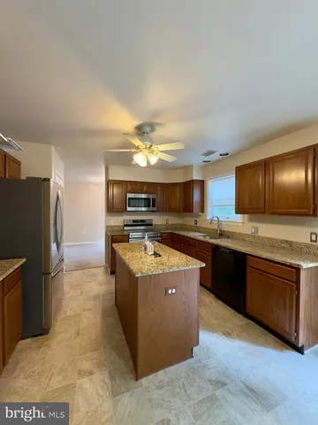 a view of empty room with window and chandelier