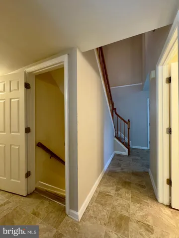 a bathroom with a toilet sink double vanity and mirror
