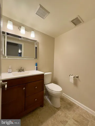 a view of a hallway with wooden floor and entryway