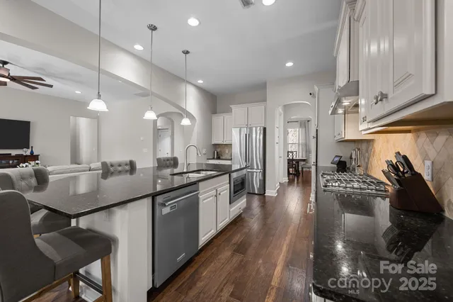 a kitchen with appliances a sink and cabinets