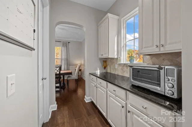 a large kitchen with granite countertop lots of counter space and a sink