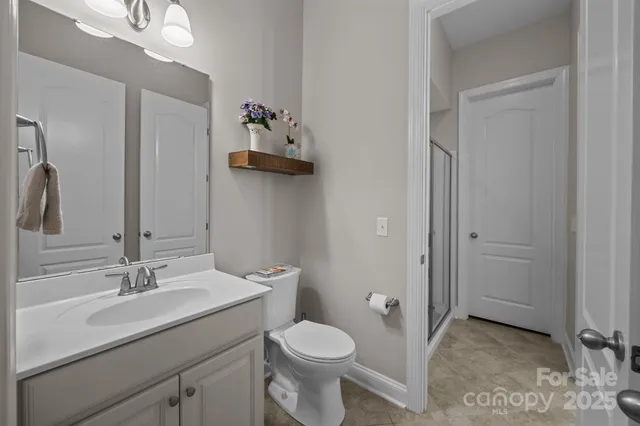 a bathroom with a shower a toilet and a sink